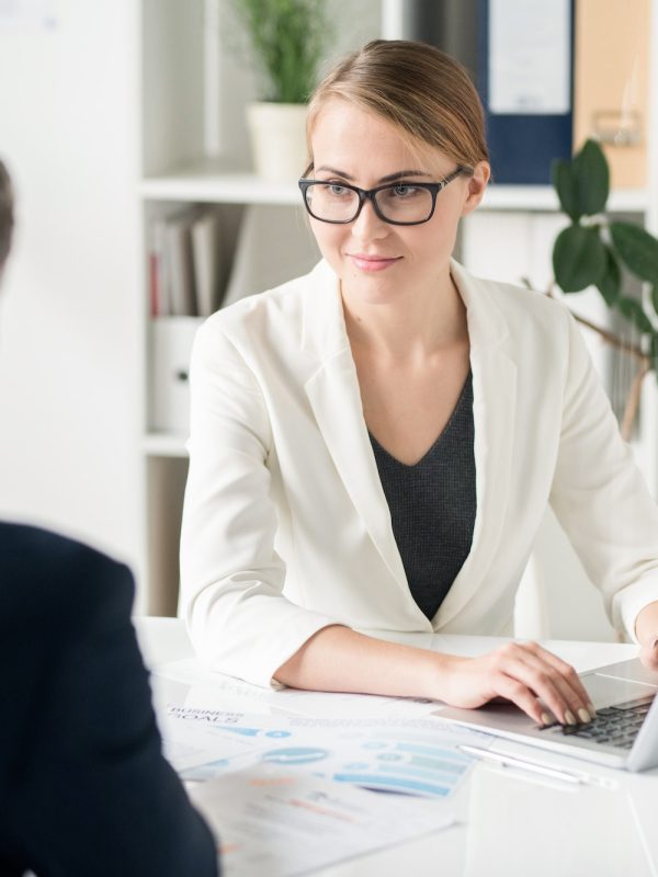 Content attractive female business consultant working with clien