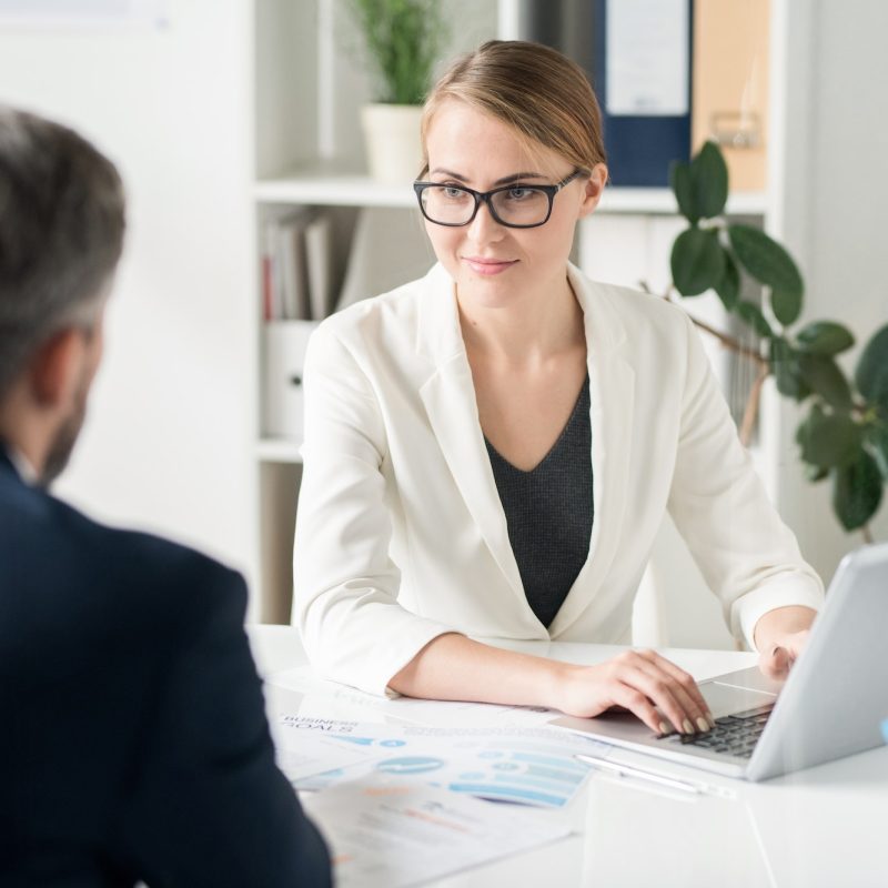 Content attractive female business consultant working with clien
